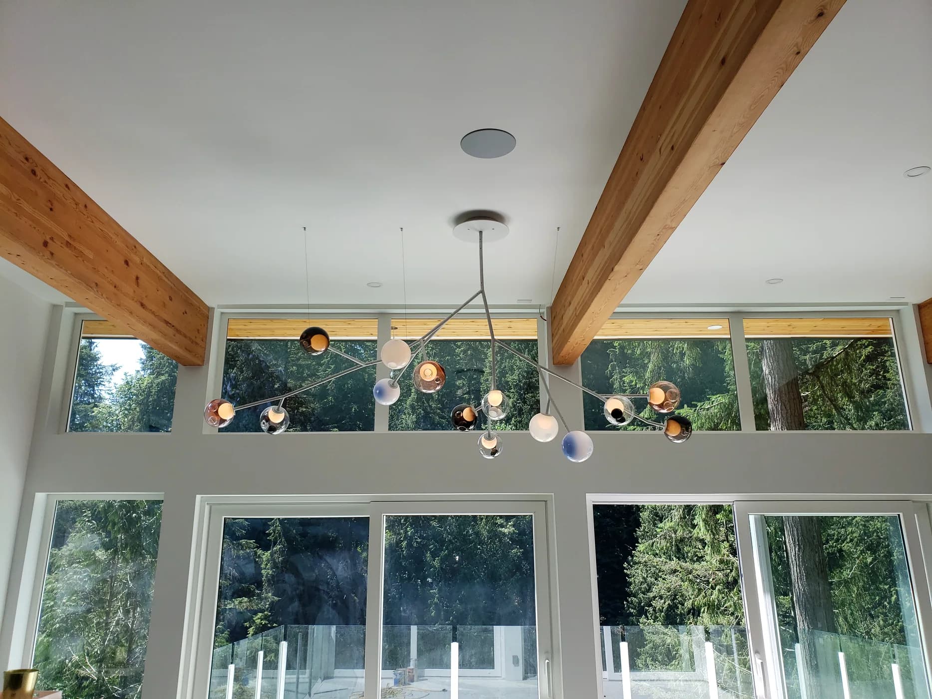 Decorative lighting installed in a bright timber-beam residence by Verity Electrical Solutions