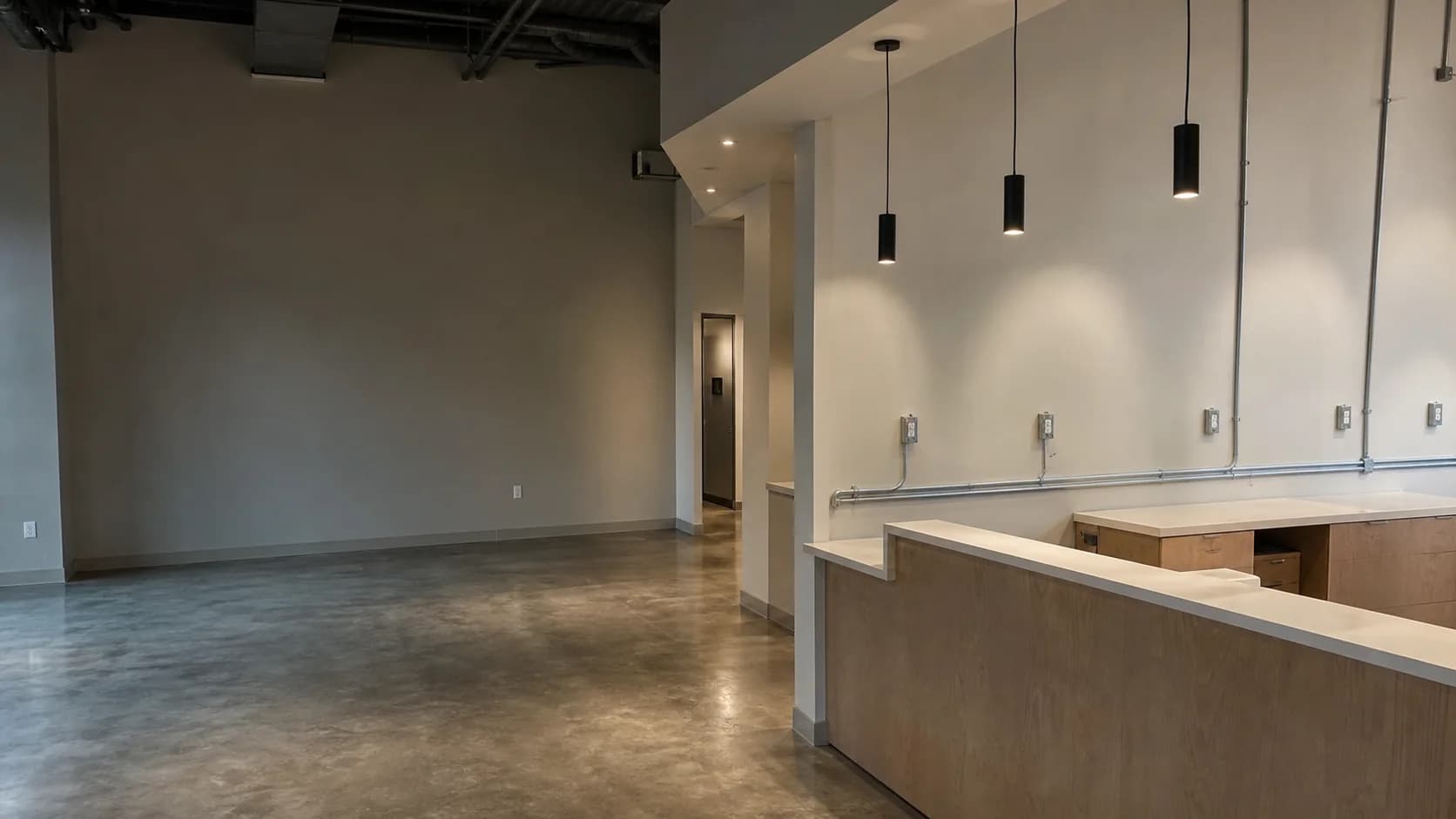 Commercial tenant space with coordinated pendant lighting, conduit and electrical devices